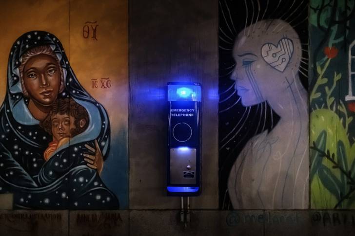 an emergency phone booth against a mural